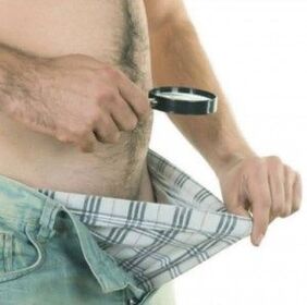 a man looks down at his pants and wants to enlarge his penis with gel